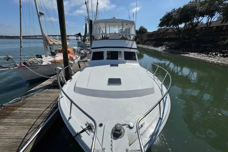 Slide: The Image of 1988 Viking 41 Convertible yacht docked by the water, sunny day. - 1