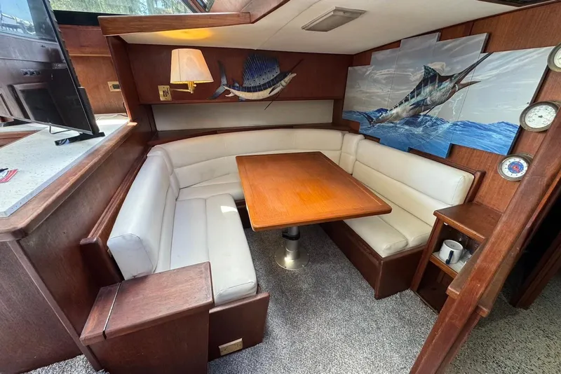 Slide: The Image of Interior of 1988 Viking 41 Convertible yacht with cozy dining area and nautical decor. - 17