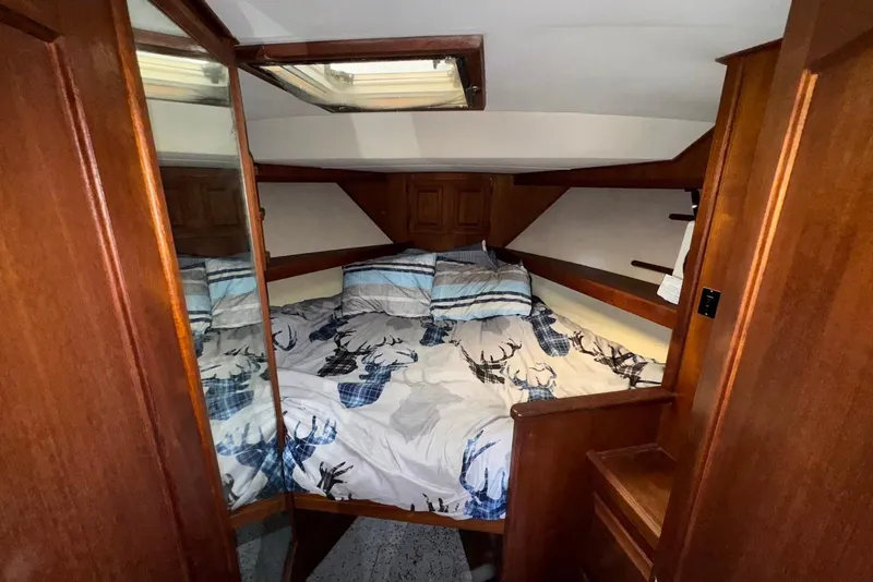 Slide: The Image of 1988 Viking 41 Convertible cabin with cozy bed and wooden interior. - 20