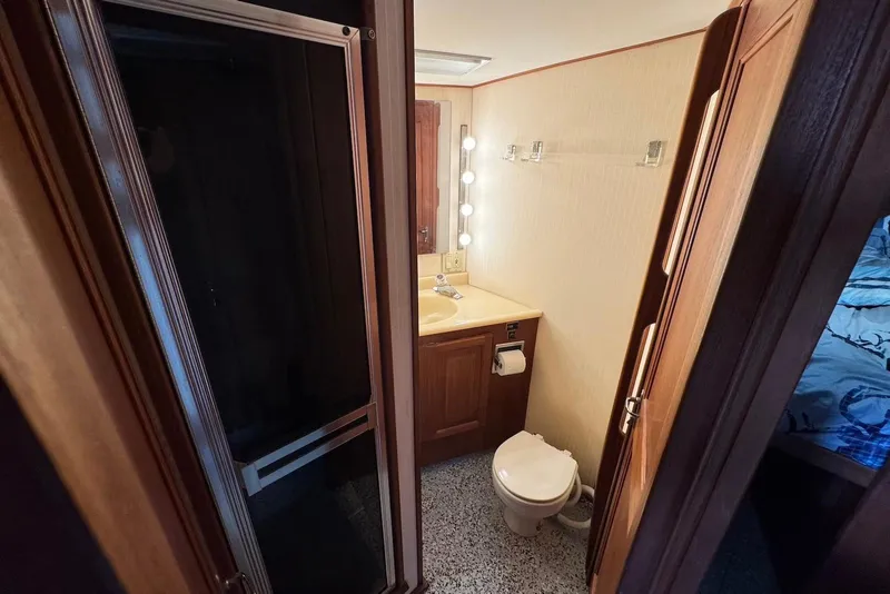 Slide: The Image of 1988 Viking 41 Convertible yacht bathroom with sink, toilet, and shower. - 21