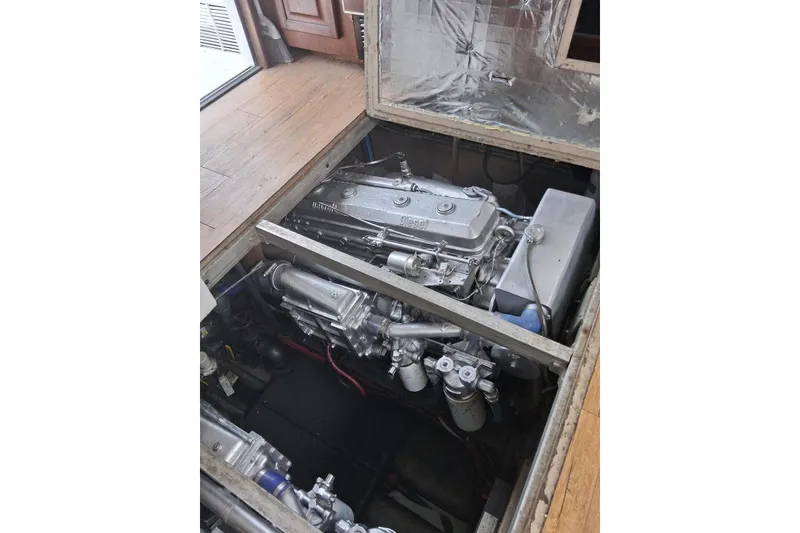 Slide: The Image of Engine compartment of a 1988 Viking 41 Convertible boat, showcasing detailed machinery. - 23