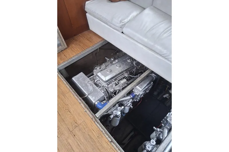 Slide: The Image of Engine compartment of a 1988 Viking 41 Convertible yacht, beneath a white sofa. - 24