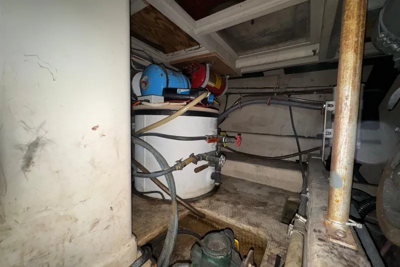 Slide: The Image of Engine room of a 1988 Viking 41 Convertible boat, showing mechanical components and piping. - 29