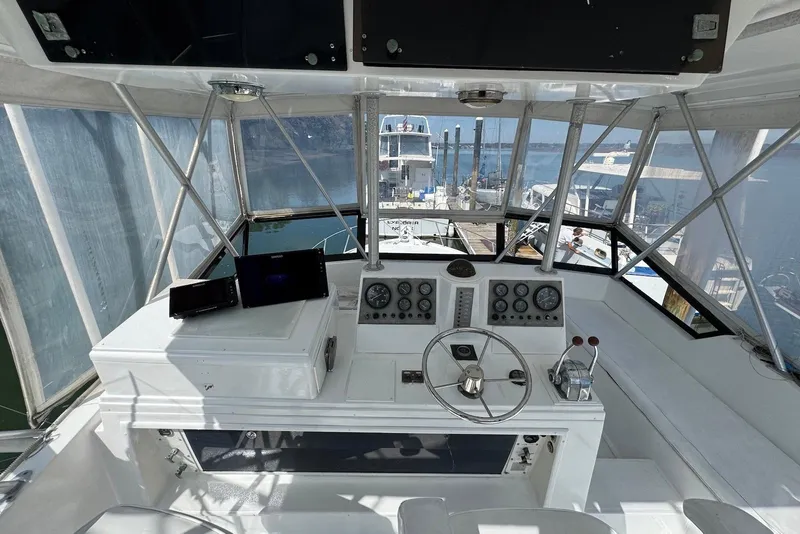 Slide: The Image of 1988 Viking 41 Convertible yacht helm with steering wheel and navigation instruments. - 9