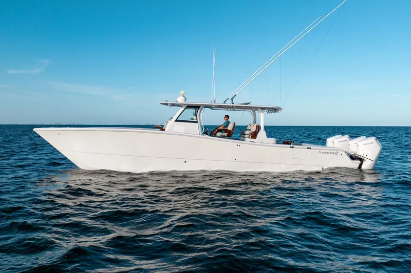 The Image of 2023 Freeman 43 boat cruising on open water under clear blue sky. - 0