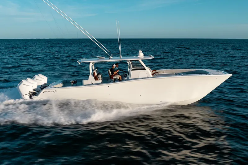 Slide: The Image of 2023 Freeman 43 boat cruising on open water under clear blue sky. - 14