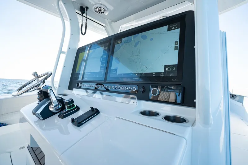 Slide: The Image of 2023 Freeman 43 boat dashboard with dual navigation screens and controls. - 19