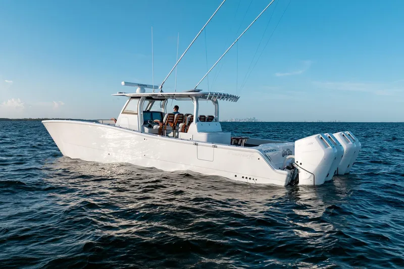 Slide: The Image of 2023 Freeman 43 boat on open water under clear blue sky. - 2