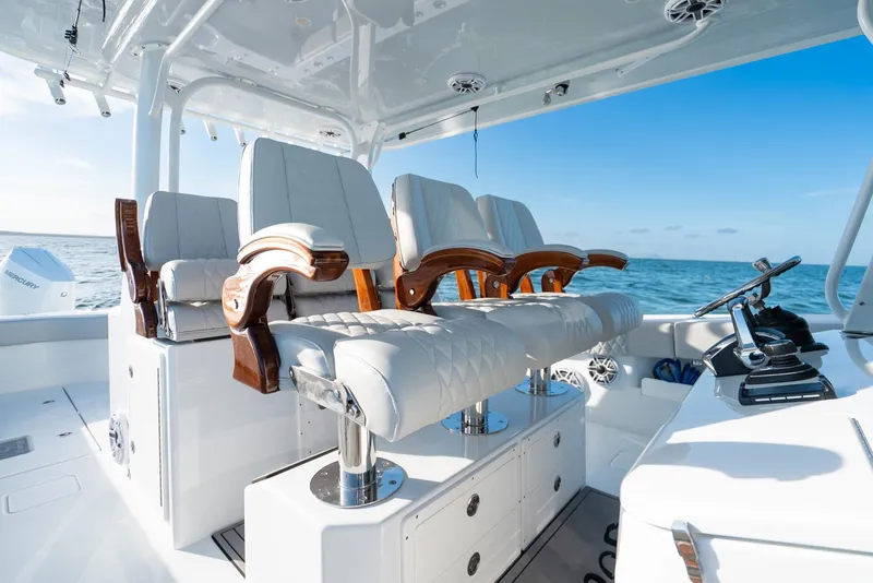 Slide: The Image of Luxurious seating on a 2023 Freeman 43 boat, featuring elegant wood accents and ocean backdrop. - 26