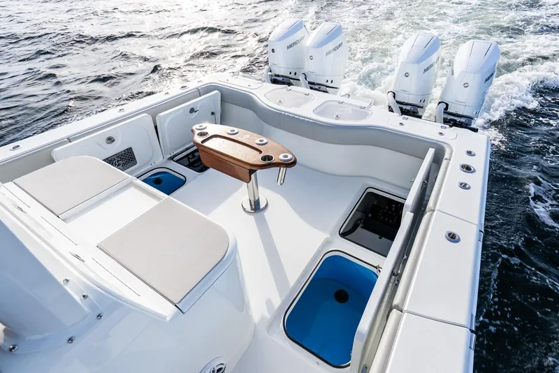 Slide: The Image of 2023 Freeman 43 boat deck with seating, fishing station, and four outboard motors. - 30