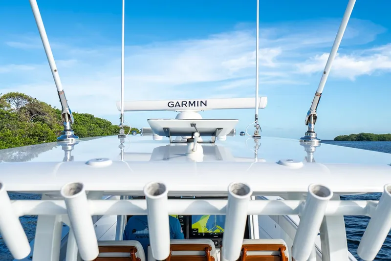Slide: The Image of 2023 Freeman 43 boat with Garmin equipment, clear blue sky, and lush greenery in the background. - 42