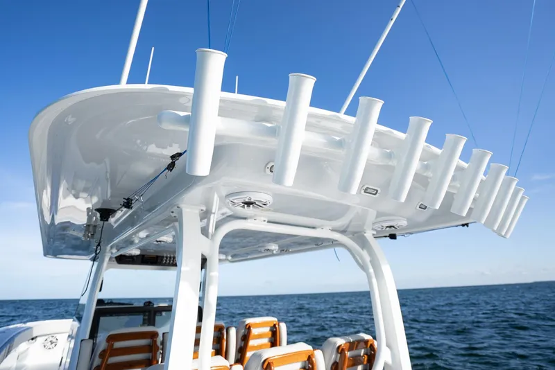 Slide: The Image of 2023 Freeman 43 boat with rod holders, ocean backdrop, clear blue sky. - 43