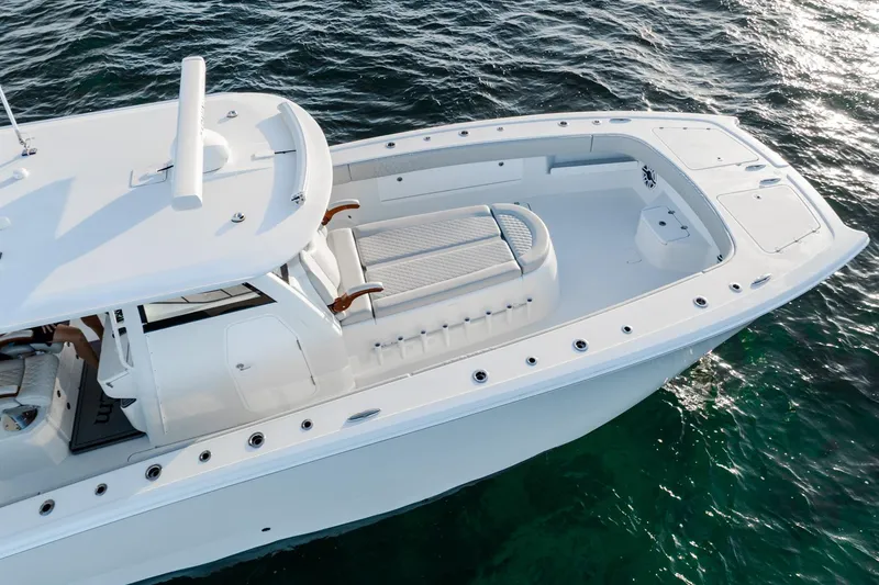 Slide: The Image of 2023 Freeman 43 boat on water, featuring sleek white design and spacious deck. - 9