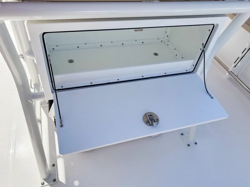 Slide: The Image of 2025 Edgewater 208CC boat storage compartment with open hatch and secure latch. - 16