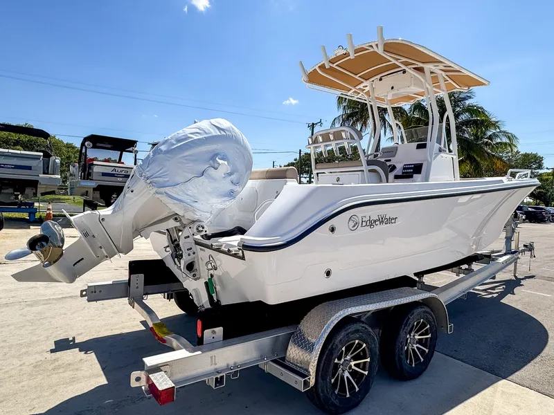 Slide: The Image of 2025 Edgewater 208CC boat on trailer, featuring a sleek design and powerful outboard motor. - 5
