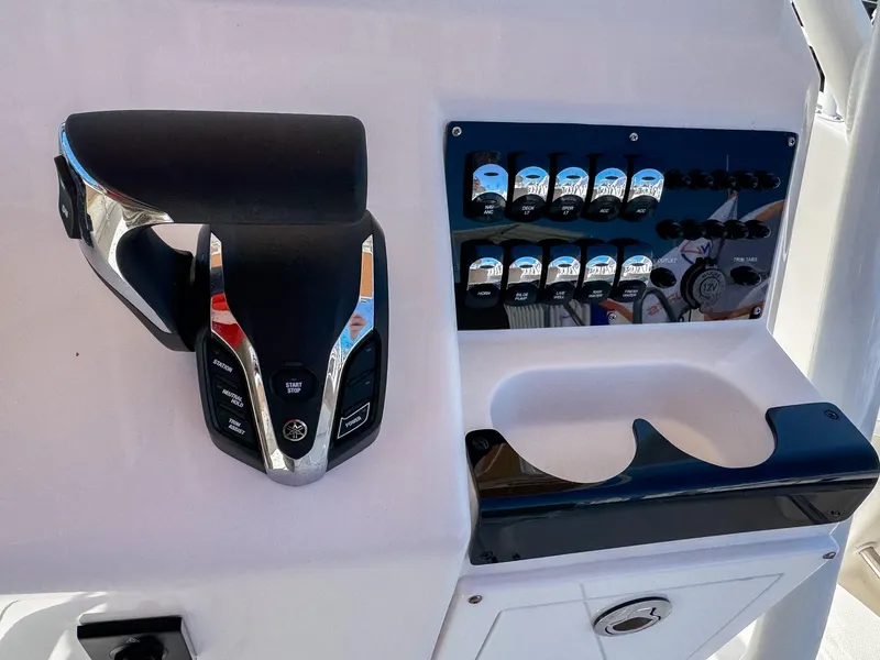 Slide: The Image of Edgewater 208CC 2025 boat control panel with throttle and switches. - 14
