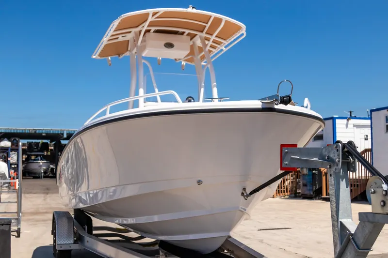Slide: The Image of 2025 Edgewater 208CC boat on trailer, displayed outdoors under clear blue sky. - 3