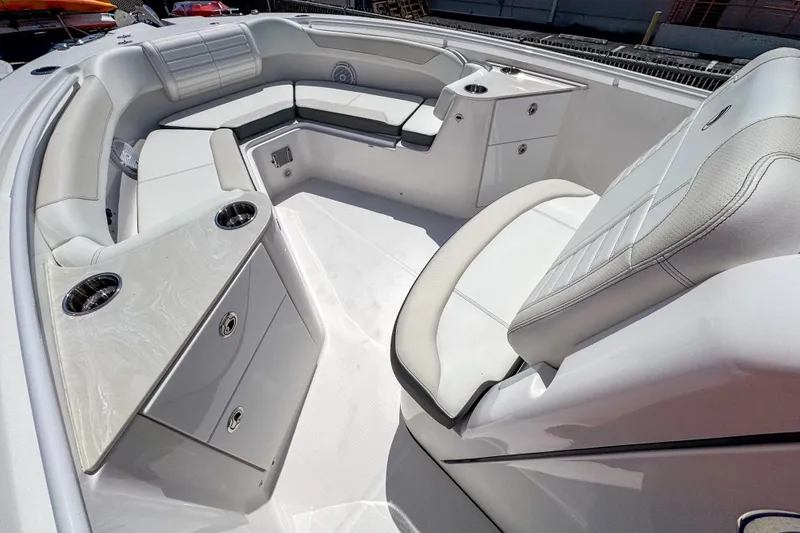 Slide: The Image of 2025 Edgewater 262CC boat interior with white seating and storage compartments. - 12