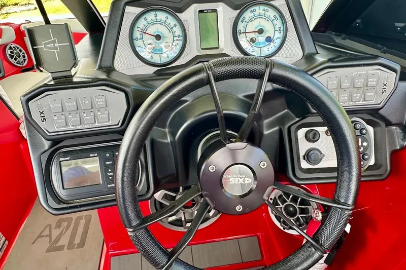 Slide: The Image of 2021 Axis A20 boat dashboard with steering wheel and control panels. - 19