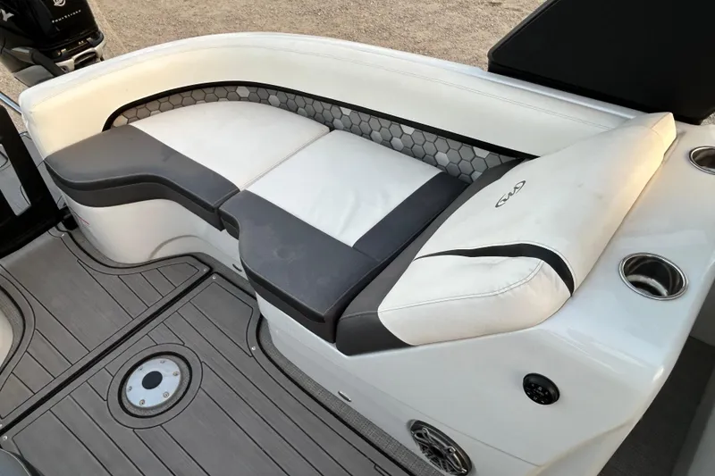 Slide: The Image of 2023 Manitou 27 XT RFXW boat interior with cushioned seating and modern design. - 10