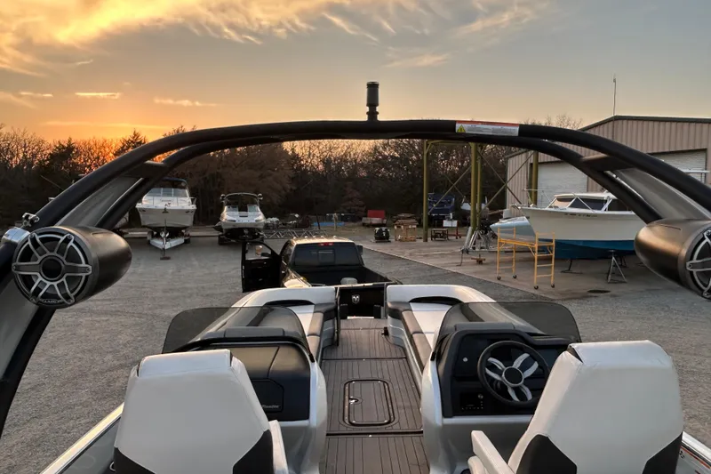 Slide: The Image of 2023 Manitou 27 XT RFXW boat at sunset in a marina setting. - 16
