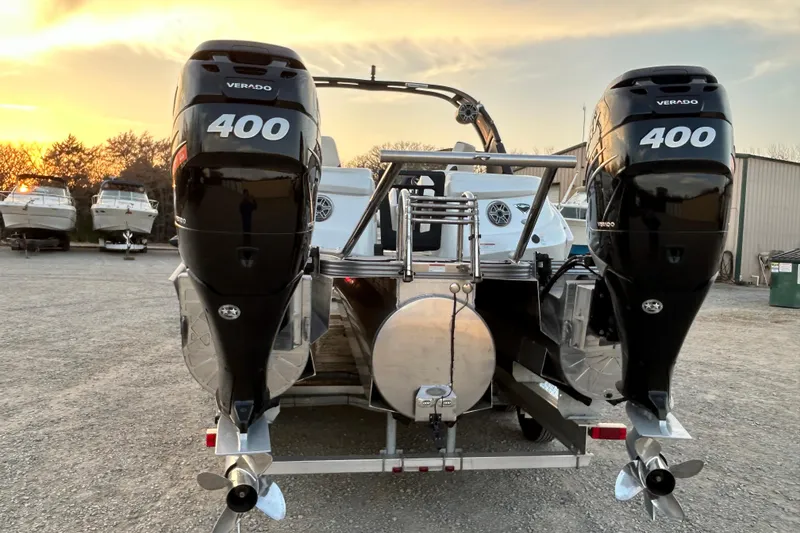 Slide: The Image of 2023 Manitou 27 XT RFXW boat with dual Verado 400 engines at sunset. - 4