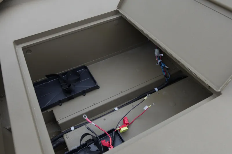 Slide: The Image of Open storage compartment of 2026 G3 Gator Tough 16 DK boat, showing wiring and battery space. - 11
