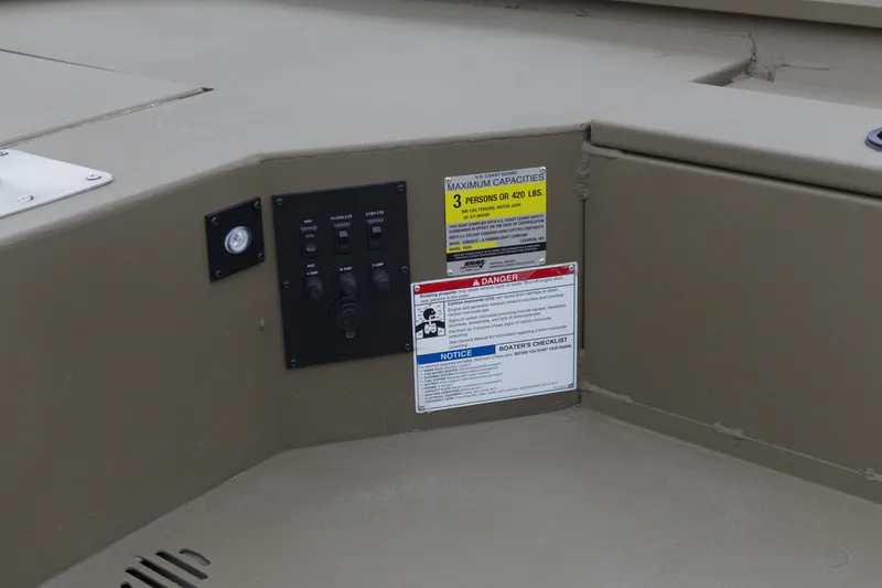 Slide: The Image of Control panel and safety labels on 2026 G3 Gator Tough 16 DK boat interior. - 9