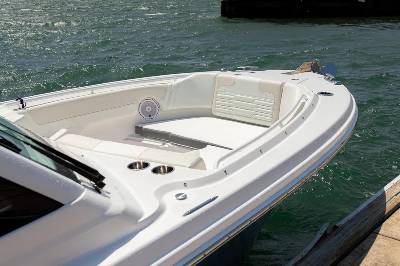 Slide: The Image of 2025 Edgewater 262 CX boat with spacious seating on calm water. - 13