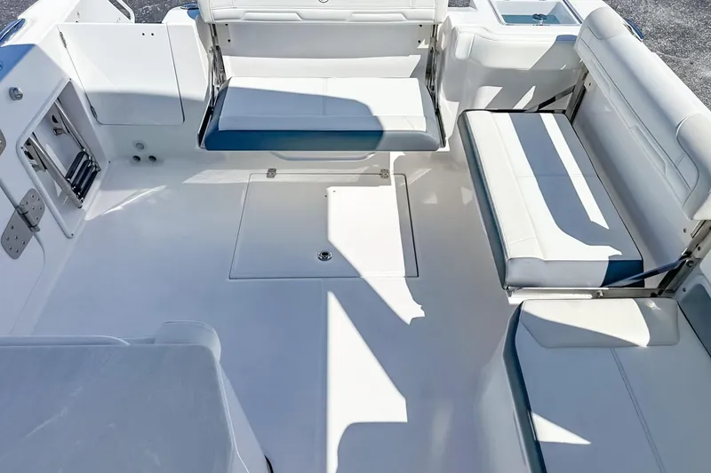 Slide: The Image of 2025 Edgewater 262CX Crossover boat interior with white seating and spacious deck layout. - 36