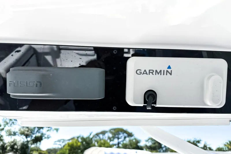 Slide: The Image of Open storage compartment on 2025 Edgewater 262 CX boat, with clear water view. - 39