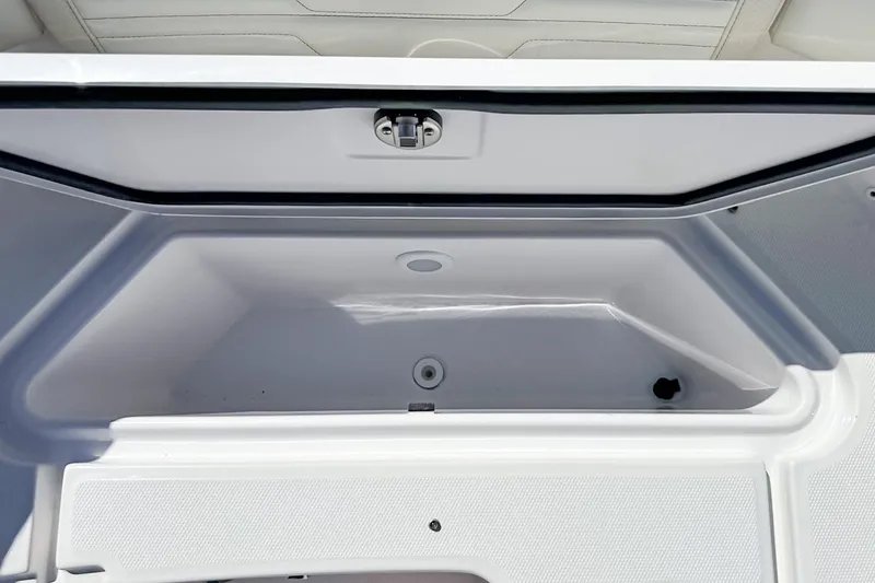 Slide: The Image of 2025 Edgewater 262 CX boat interior with kitchenette and seating area. - 44