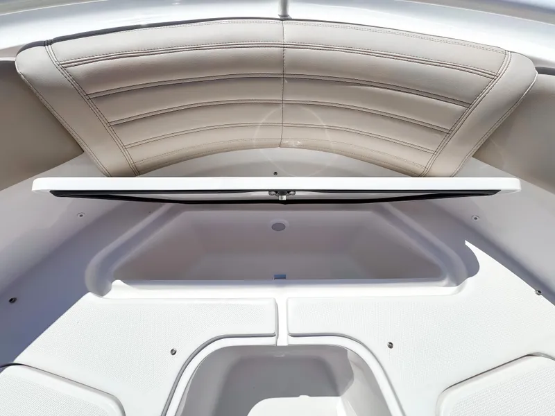 Slide: The Image of 2025 Edgewater 325CC boat interior with open storage compartment and cushioned seating. - 26