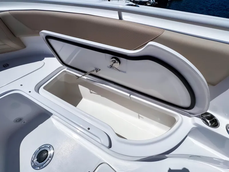 Slide: The Image of Open storage compartment on 2025 Edgewater 325CC boat, featuring sleek design and ample space. - 27