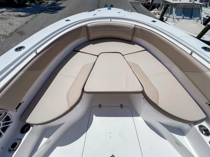 Slide: The Image of 2025 Edgewater 325CC boat with spacious, cushioned seating area in the bow. - 29