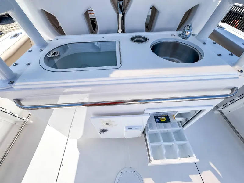 Slide: The Image of 2025 Edgewater 325CC boat with sink and storage compartments in the cockpit area. - 17