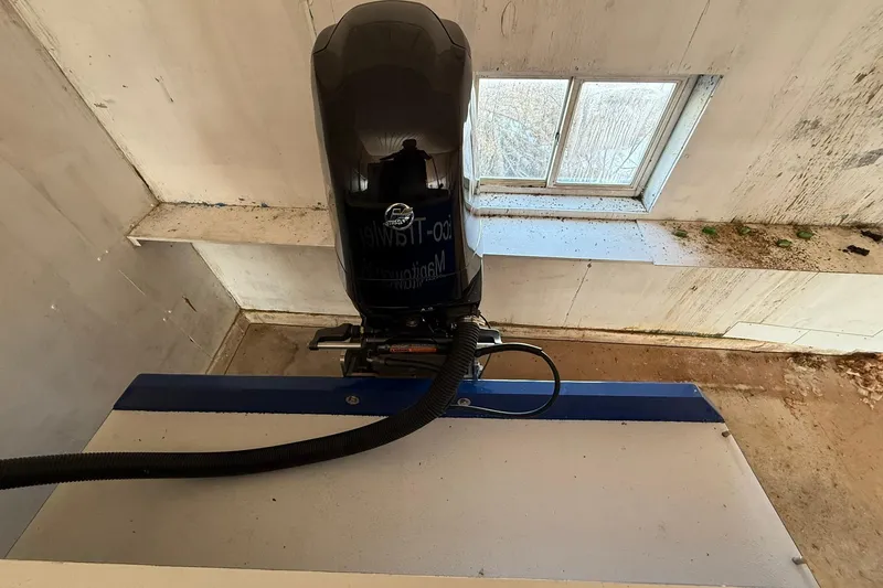 Slide: The Image of Outboard motor of a 2013 Eco-Trawler 33 in a workshop setting. - 11