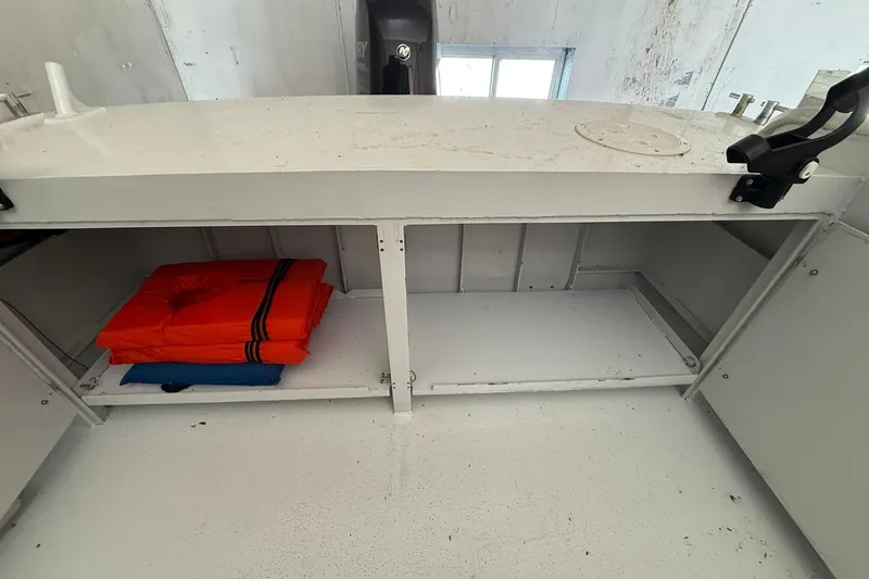 Slide: The Image of Storage compartment on 2013 Eco-Trawler 33 with life jackets and safety equipment. - 15