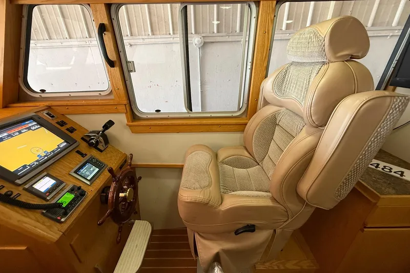 Slide: The Image of Pilot seat and control panel of 2013 Eco-Trawler 33, featuring navigation equipment. - 18
