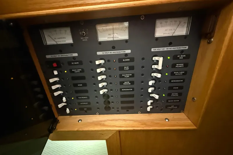 Slide: The Image of Electrical control panel on 2013 Eco-Trawler 33 boat, featuring various switches and meters. - 26