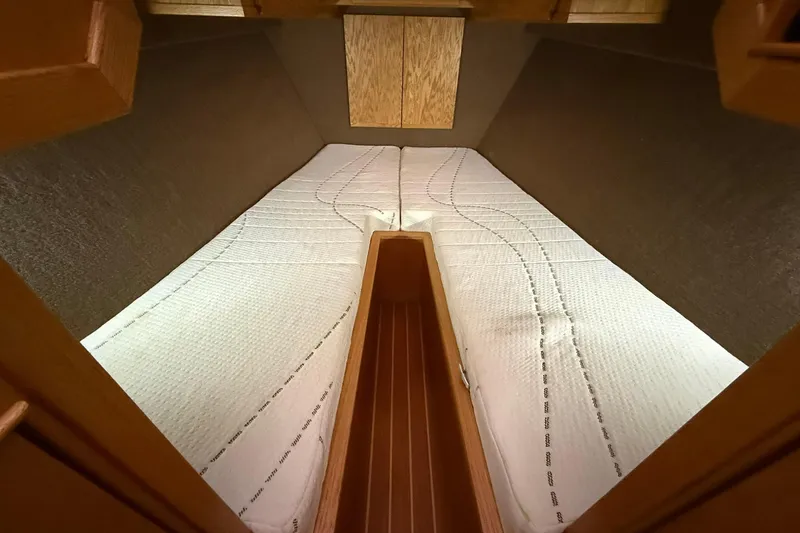 Slide: The Image of Cozy cabin interior of 2013 Eco-Trawler 33 with twin beds and wooden accents. - 28