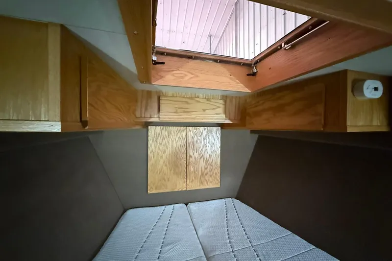 Slide: The Image of Cozy cabin interior of 2013 Eco-Trawler 33 with wooden accents and overhead hatch. - 29