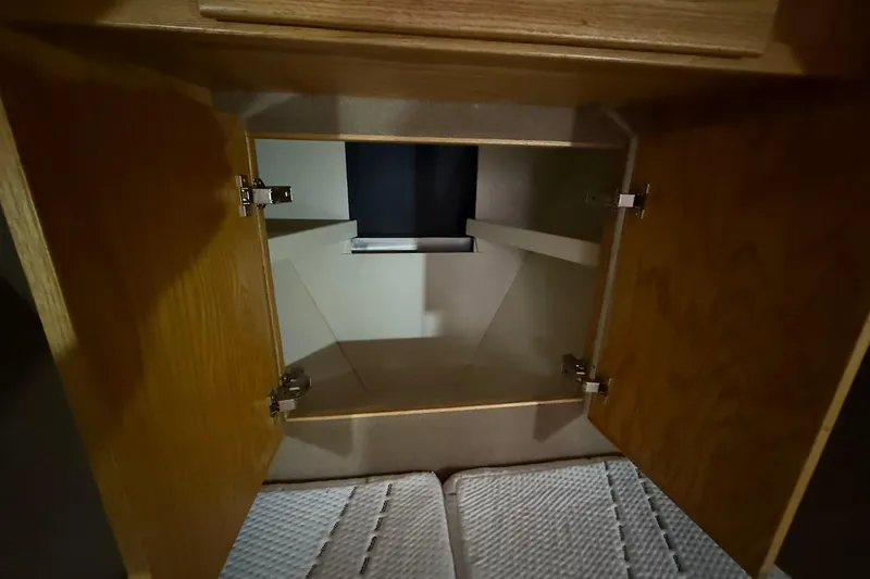 Slide: The Image of Open wooden cabinet inside 2013 Eco-Trawler 33 boat, showcasing interior storage space. - 30