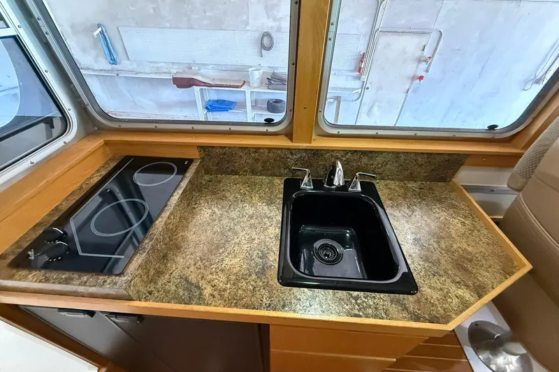 Slide: The Image of Compact kitchen area in 2013 Eco-Trawler 33 with sink and electric stove. - 31