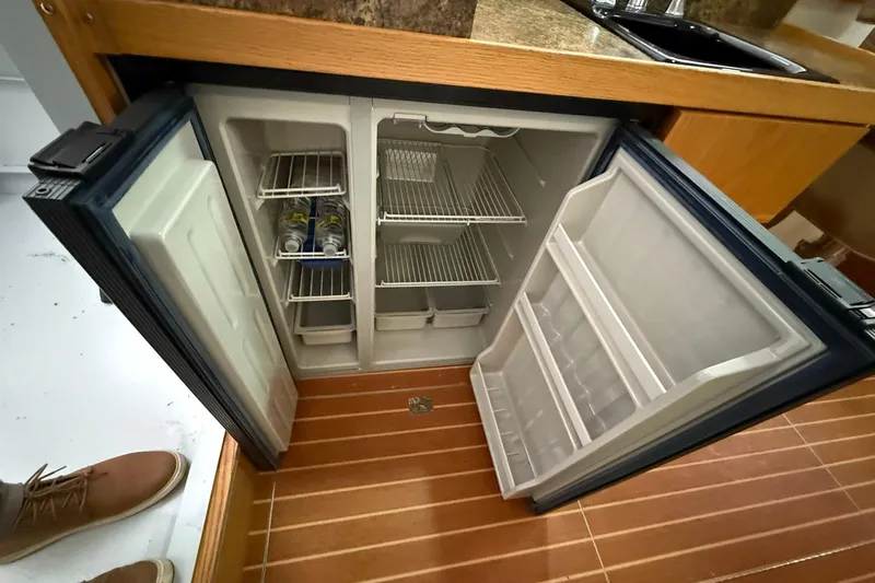 Slide: The Image of Open fridge on Eco-Trawler 33, 2013 model, with wooden flooring and countertop. - 34