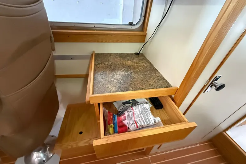 Slide: The Image of Interior of 2013 Eco-Trawler 33 with open wooden drawer and countertop. - 37