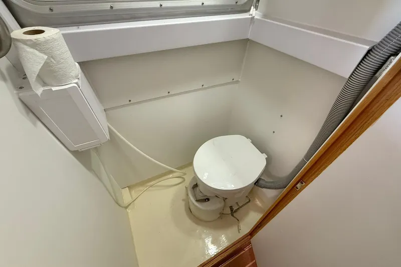 Slide: The Image of Compact bathroom in 2013 Eco-Trawler 33 with toilet and paper holder. - 39