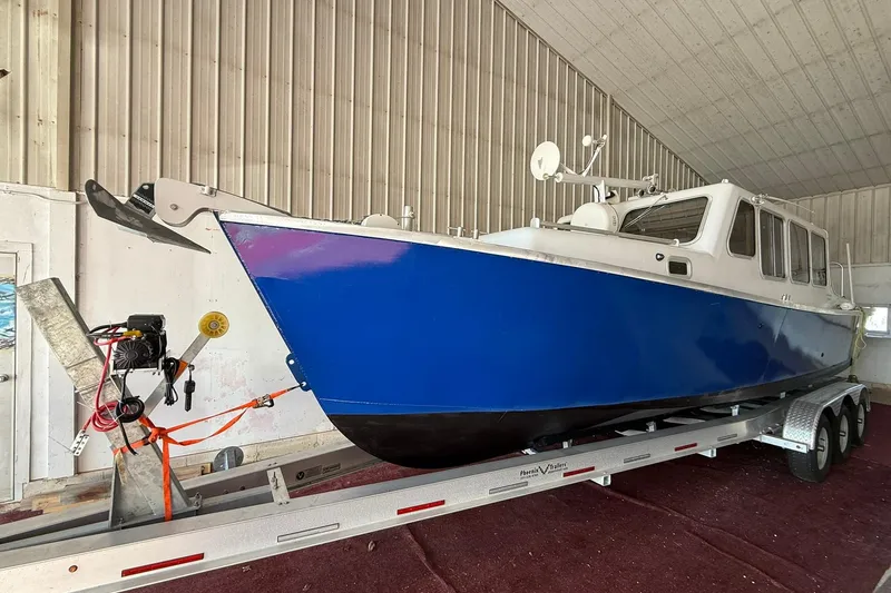Slide: The Image of 2013 Eco-Trawler 33 boat on trailer in indoor storage facility. - 4