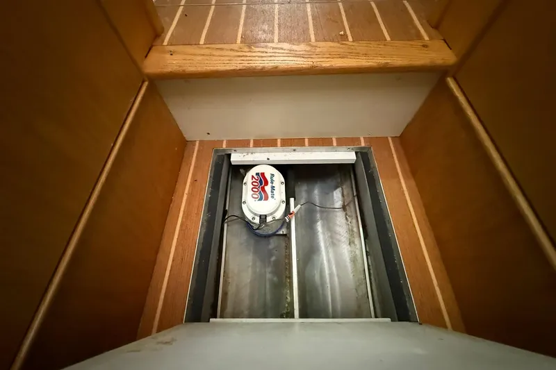 Slide: The Image of Bilge pump in 2013 Eco-Trawler 33, wooden flooring, open hatch view. - 40