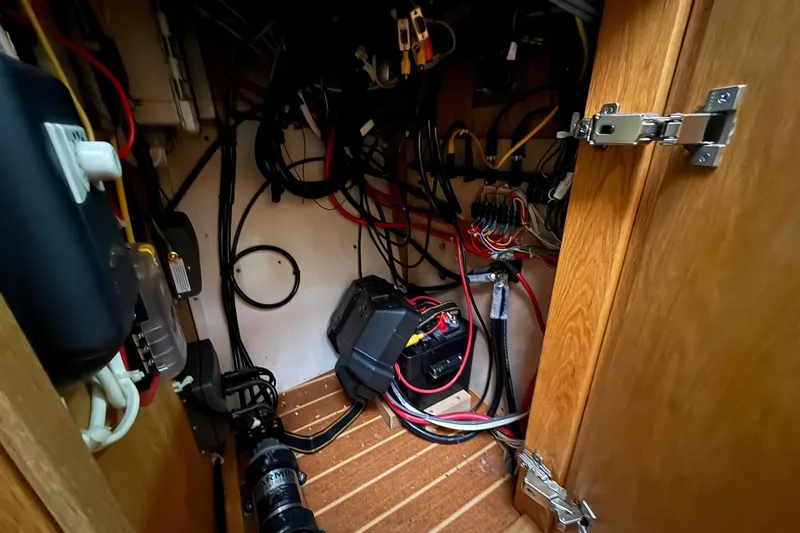 Slide: The Image of Electrical wiring and components inside a 2013 Eco-Trawler 33 boat cabinet. - 41